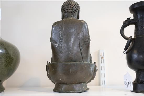 A Chinese bronze seated figure of Buddha Shakyamuni, 17th century, H. 32cm